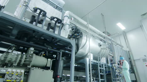 scientist with uniform in drug manufacturing technology production high-tech pharmaceutical processing equipment for biopharmaceutical in modern industrial facility with advanced control systems