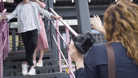 couple posing for photos on stairs