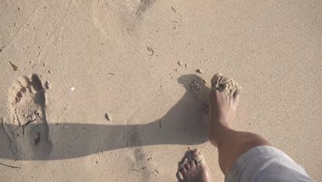 Cinematic-shot-of-a-person-walking-on-a-white-sand-beach-in-a-tropical-country-of-the-Philippines