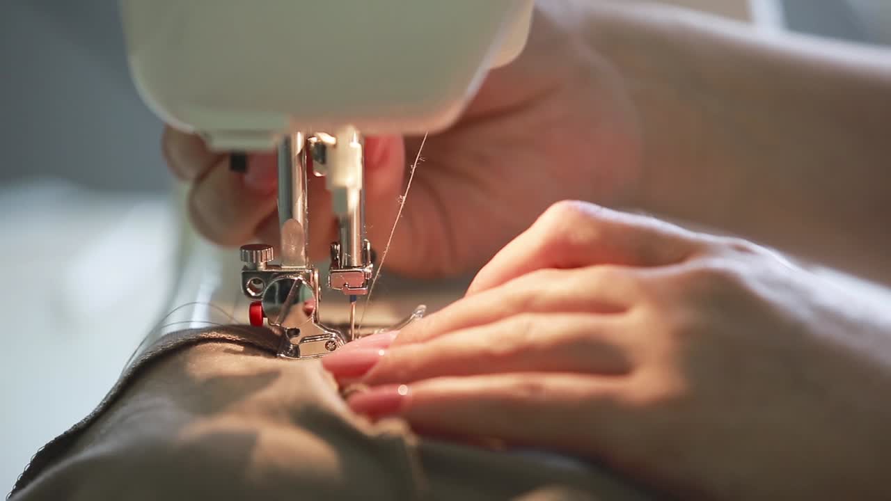 Woman Sewing at Home. Close up of working sewing machine at home