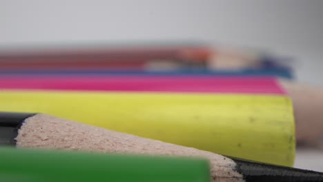 close-up of black pencil amidst colorful ones