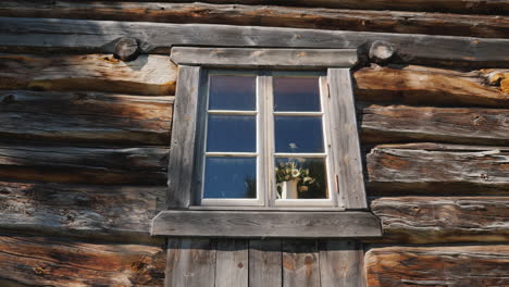 ventana con flores en un alféizar en una vieja casa de madera 4k video
