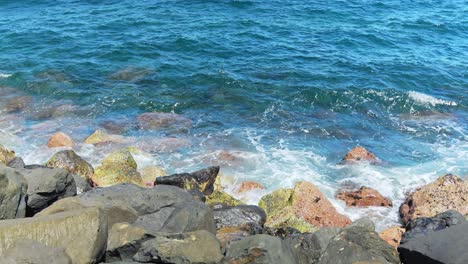 atlantic ocean waves flowing over rocky coastline, slow motion view