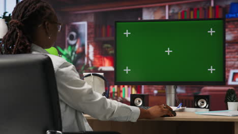 teleworker using green screen pc in home office to write emails