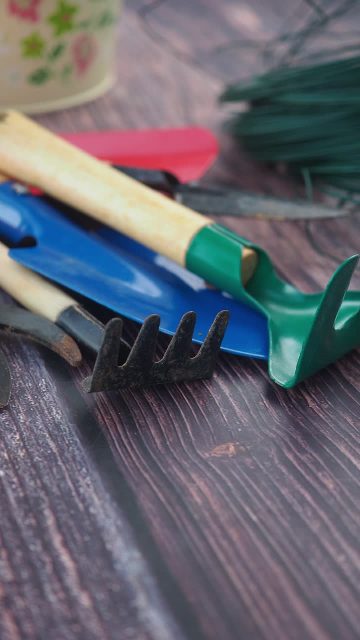 Collection of Various Gardening Tools on a Wooden Surface