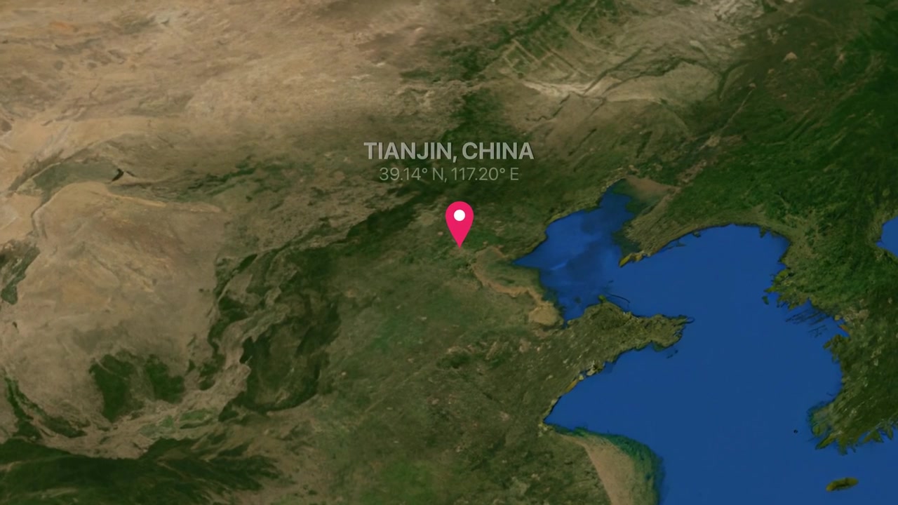 A digital earth render zooms from a global view into Tianjin China with map marker
