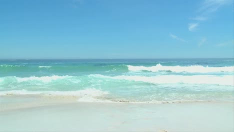 man with surfboard getting out of the water