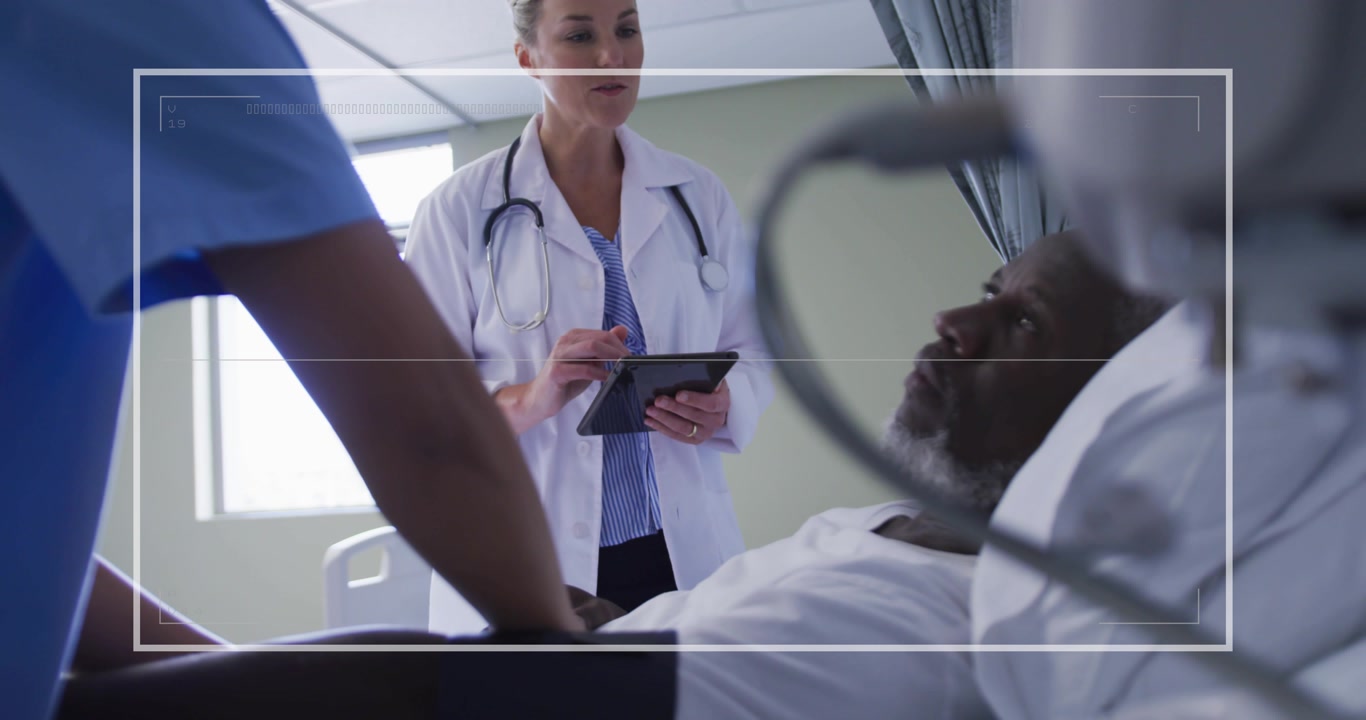 Nurse palpating patient abdomen bedside while doctor tapping tablet and animating biometric overlay
