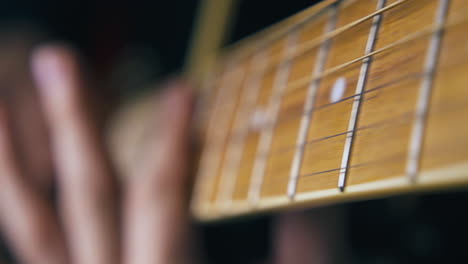 skilled-musician-performs-barre-chord-on-acoustic-guitar