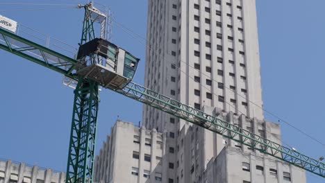 a construction crane lifting materials on a building site in argentina, depicting urban growth