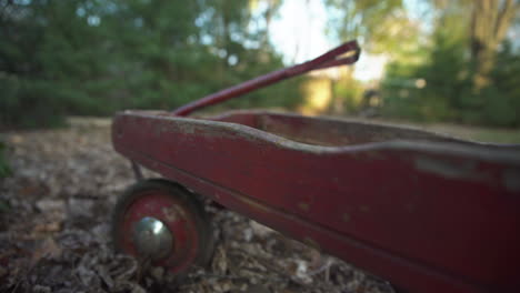 close up of the rotten and broken wood on an old damaged child's red wagon