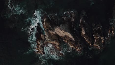 waves splashing on sea rocks in mazunte, mexico - aerial top down