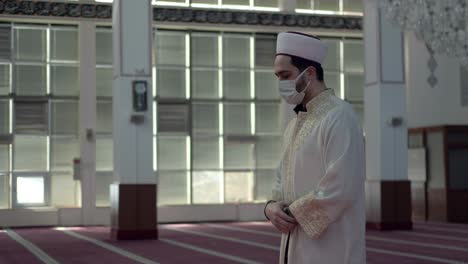 man wears a mask and worships in the mosque