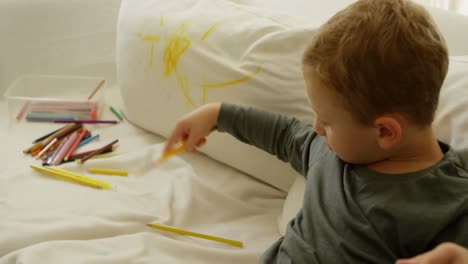 Boy-with-color-pencil-on-sofa-4k