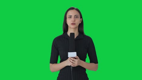 Indian-female-news-reporter-talking-to-the-camera-Green-screen