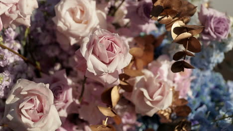 Bouquet-of-pink-roses-in-sunlight-moving-in-wind