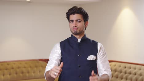 Disappointed-Indian-man-showing-thumbs-down