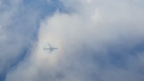 shadow of an airplane casted on a cloud with a brocken spectre or a so called solar glory
