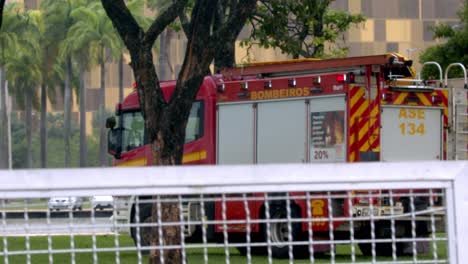 red firetruck in a park during rain