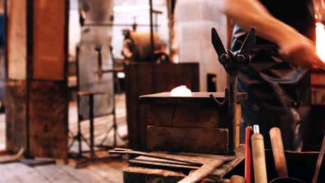 glassblower working on molten glass