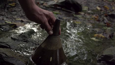 setting fire to a gas leak in a pond through a funnel