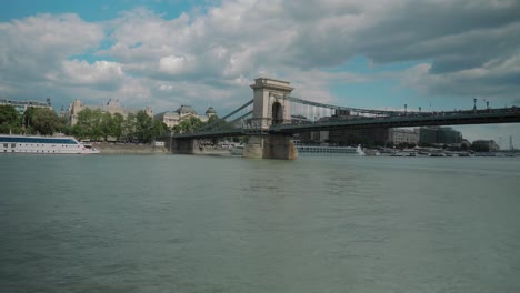 Boat-ride-through-Danube,-summer-afternoon,-approaching-chain-bridge