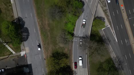 an aerial view over a grassy median between multilane roads