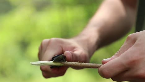 man using knife in forest