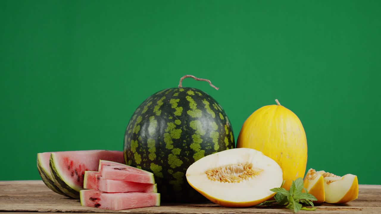 Fresh watermelon and melon on a wooden table.
