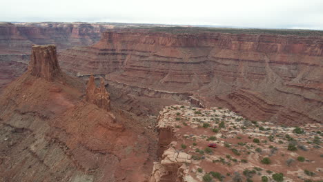 Aerial-View-of-Red-Offroad-Vehicle-Approaching-to-Marlboro-Point-Lookout-Above-Landscape-of-Utah-USA