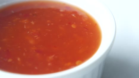 tomato sauce in a jar with fresh tomato on table