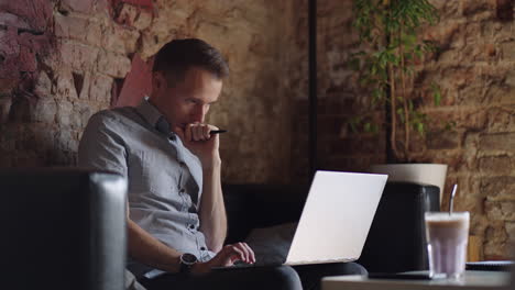 Thoughtful-serious-young-man-student-writer-sit-at-home-office-desk-with-laptop-thinking-of-inspiration-search-problem-solution-ideas-lost-in-thoughts-concept-dreaming-looking-away