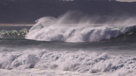 Surfer-on-a-big-wave-manoeuvres-skillfully-and-avoids-breaking-the-wave