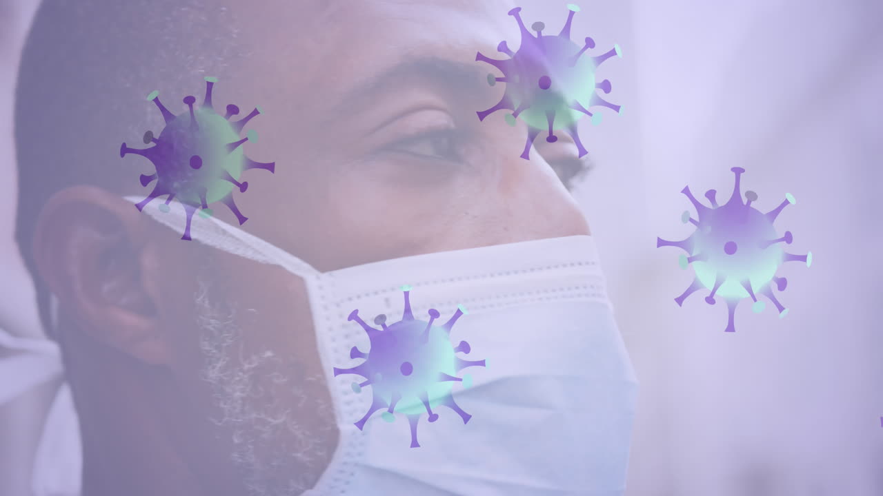 Multiple covid-19 cells moving against close up of african american senior man wearing face mask