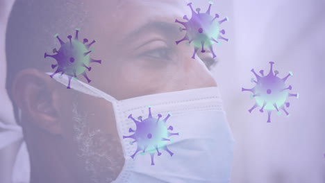 múltiples células de covid-19 que se mueven contra el primer plano de un hombre mayor afroamericano que usa una máscara facial