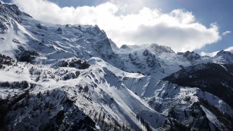 a breathtaking aerial view of snow-covered mountain peaks, showcasing serene alpine landscapes and crisp natural beauty during winter