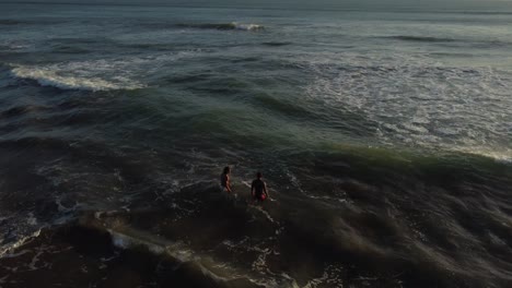 AERIAL:-Drone-shot-showing-people-swimming-in-the-ocean