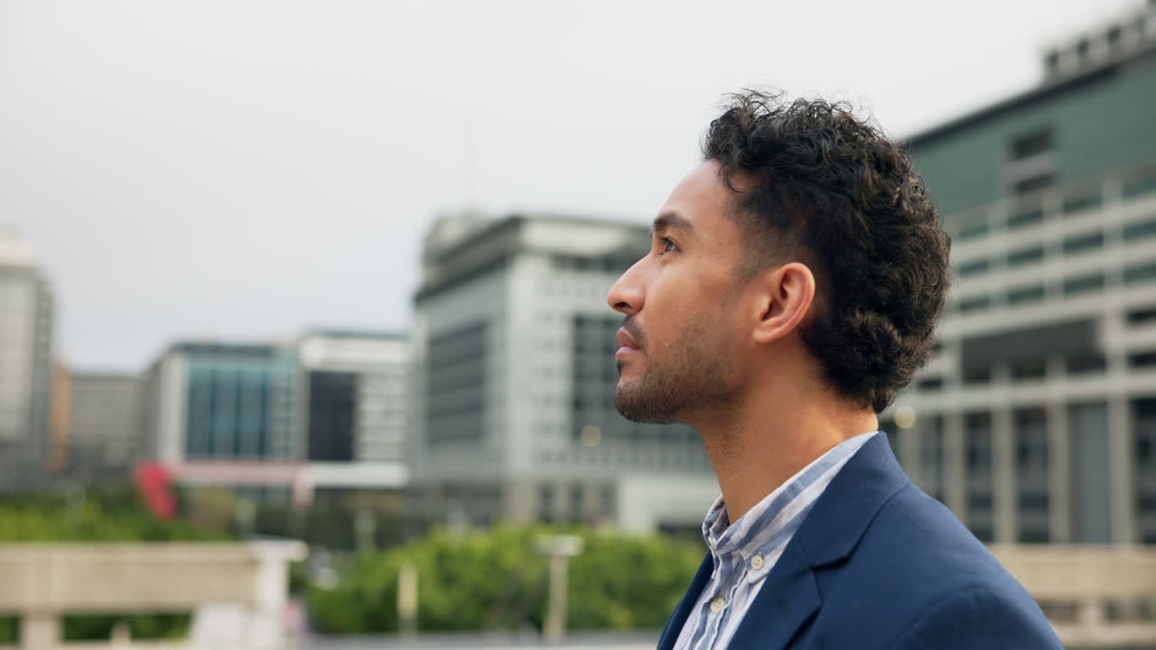 Man in a suit looking up in the city