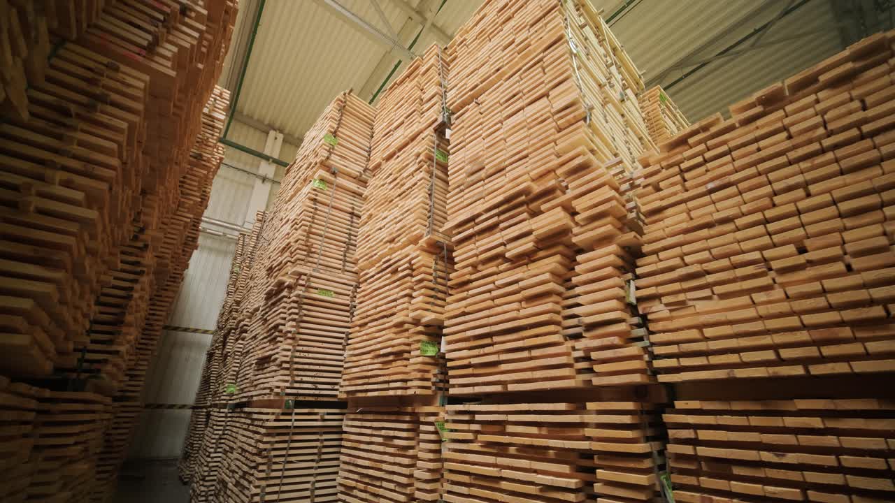 Tall Stacks of Wooden Planks in an Industrial Warehouse