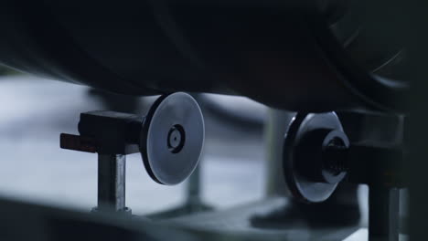 detailed tire tape spinning on automated robotic machine in factory closeup