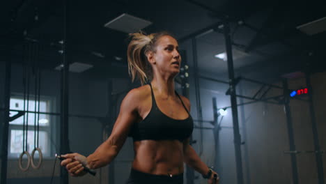 slow motion: skipping woman training at the gym. young woman skipping rope. athlete female jumping on skipping rope at cardio training in gym club.