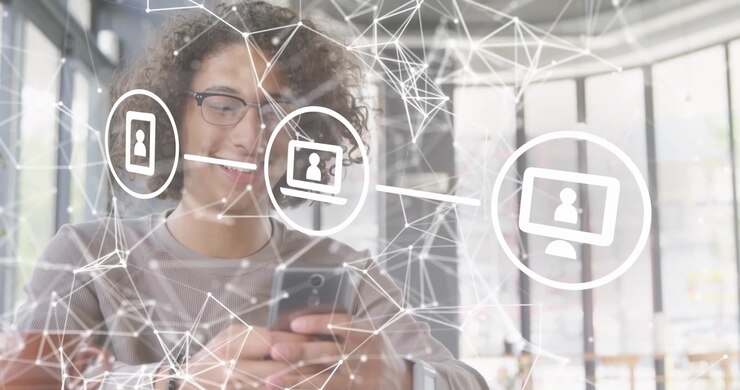 Tech worker tapping smartphone screen activating network overlay visualizing data flow to devices