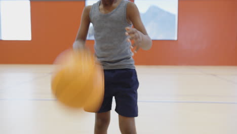 playing basketball in school gym, child holding ball and preparing to shoot