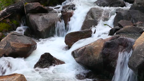 a stream or river flows over boulders