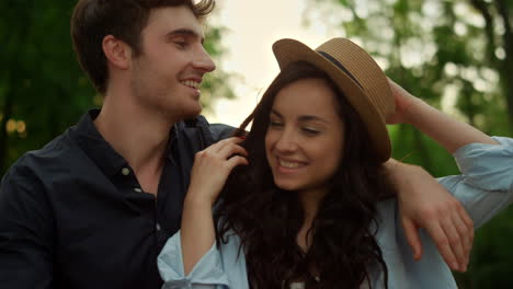 happy couple walking in park and having fun on romantic date at sunset.