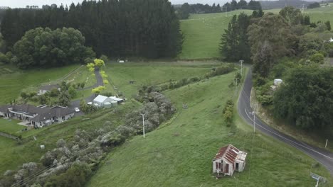 Aerial view of a rural landscape with fields, trees, houses, and a road