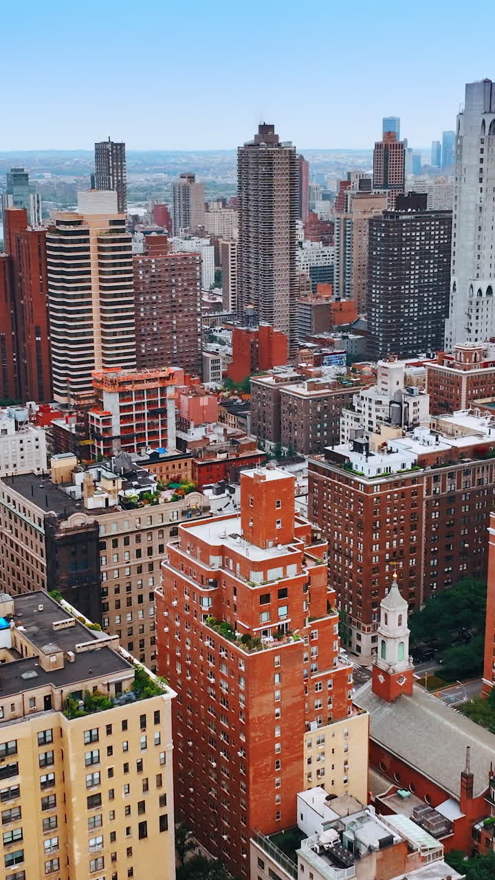 Colorful bright cityscape of New York. Drone footage above the metropolis panorama at daytime. Vertical video