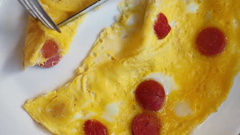 close-up of a delicious omelet with red sausage