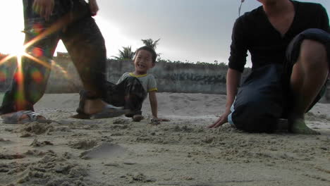 four kids play with crab