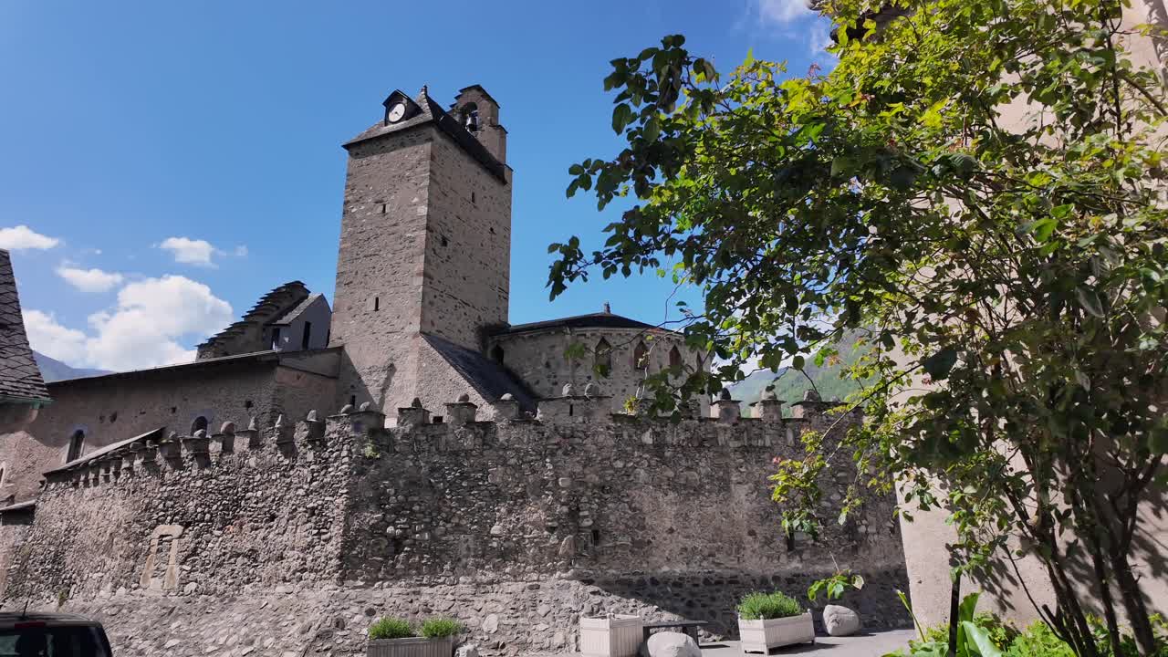Rear view on the templar church in Luz Saint Sauveur, a picturesque village in the French pyrenees. Dolly move.